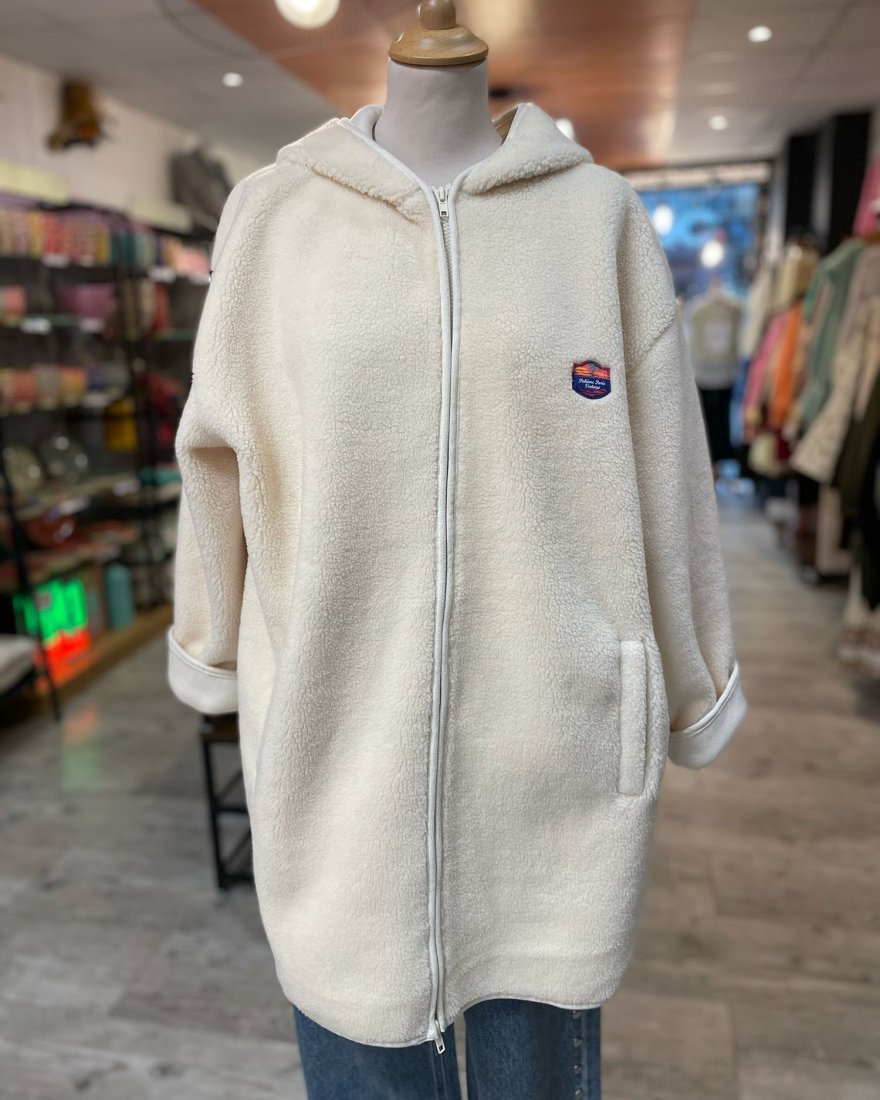 Manteau long en moumoute écru avec une capuche
